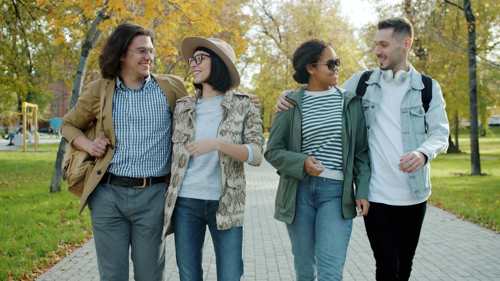 A group of friends walking and talking together in a park