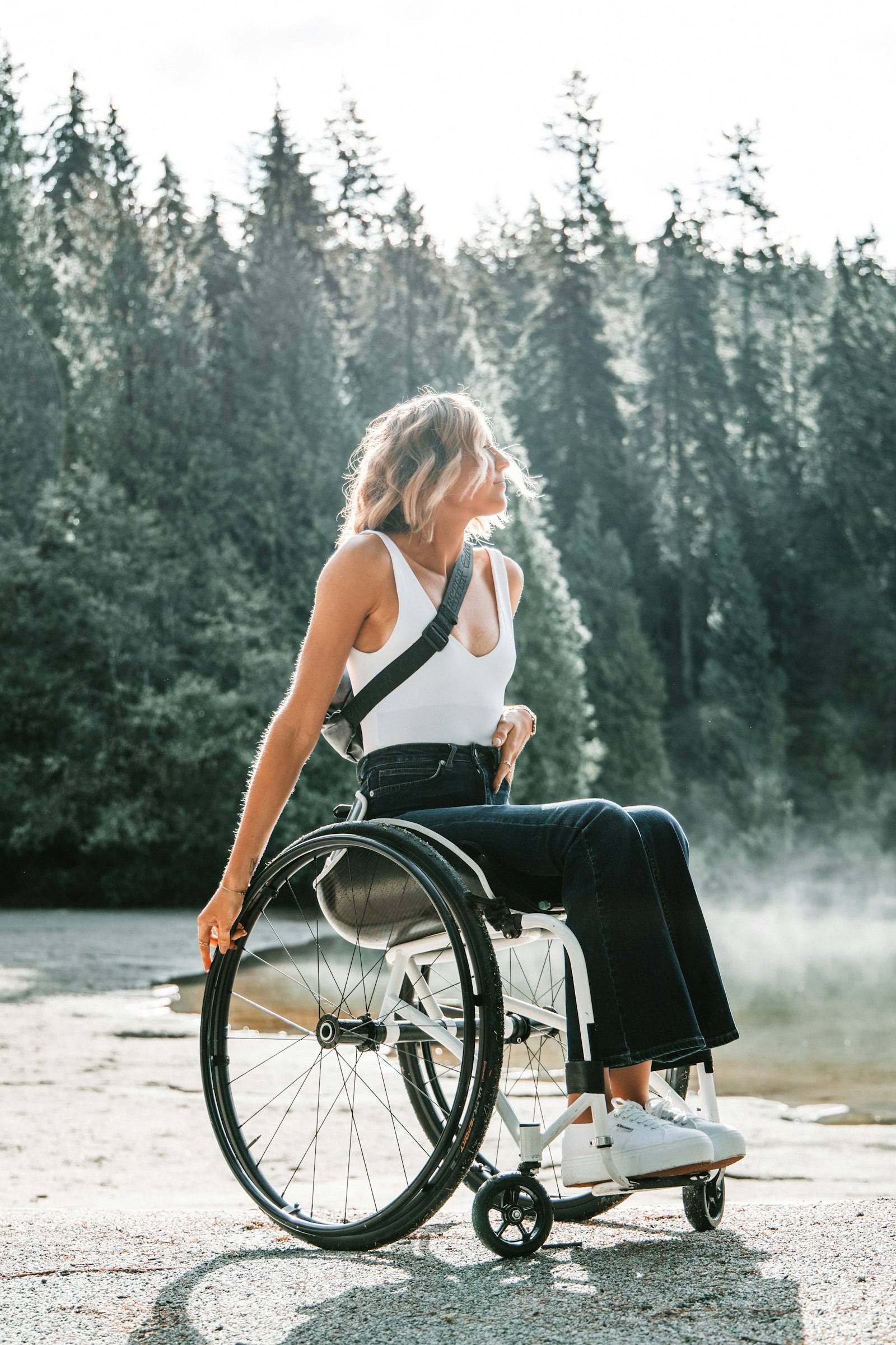 A woman using a wheelchair outdoors enjoying time in nature